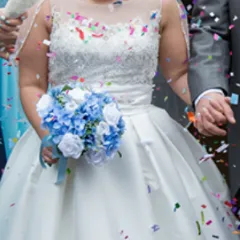 A bridal bouquet collection of white or ivory roses plus blue artificial silk hydrangea